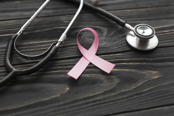 foto con stetoscopio e un nastro rosa intrecciato simbolo di prevenzione contro i tumori